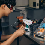 man working with electronics on table
