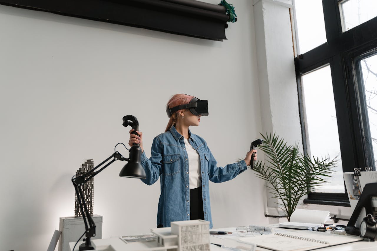Woman wearing VR headset and denim jacket explores virtual world in a contemporary office.